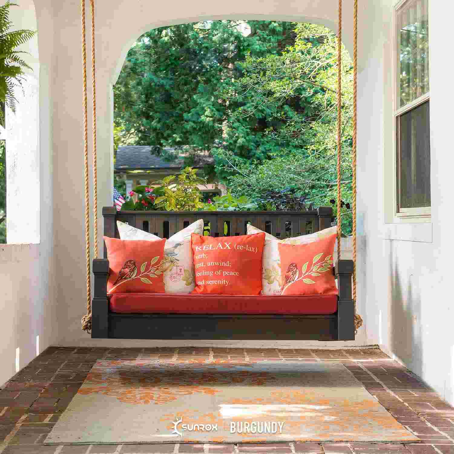 Swing seat on patio with red patio cushions