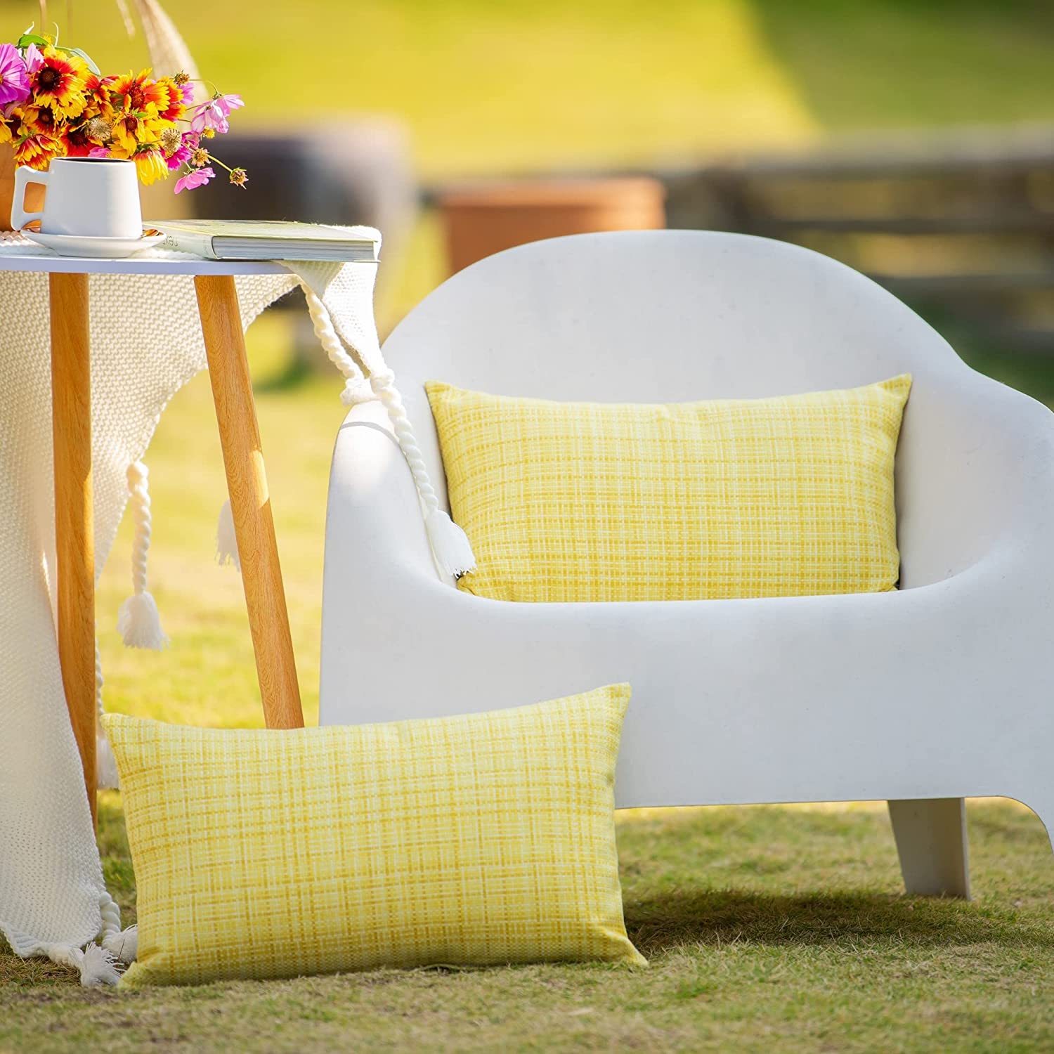 white outdoor chair with side table and lovely bright yellow cushions